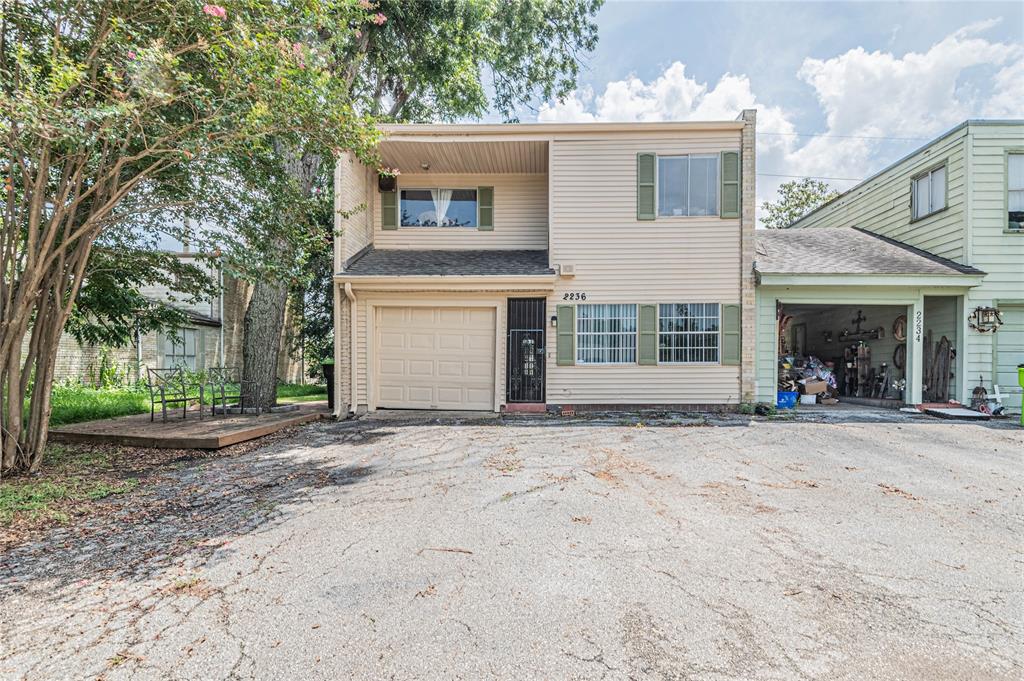 a view of a house with a patio and a yard