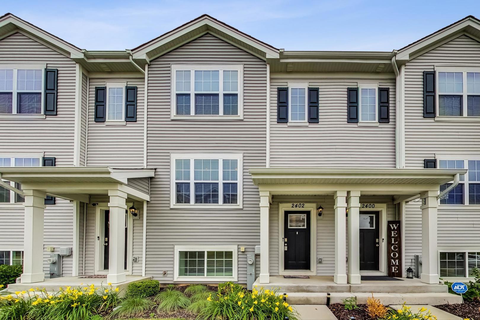 a front view of a residential apartment building with a yard