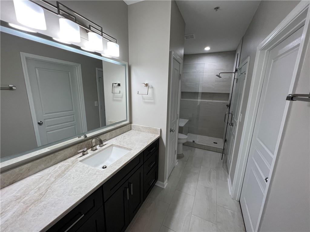 a bathroom with a double vanity sink and mirror with shower