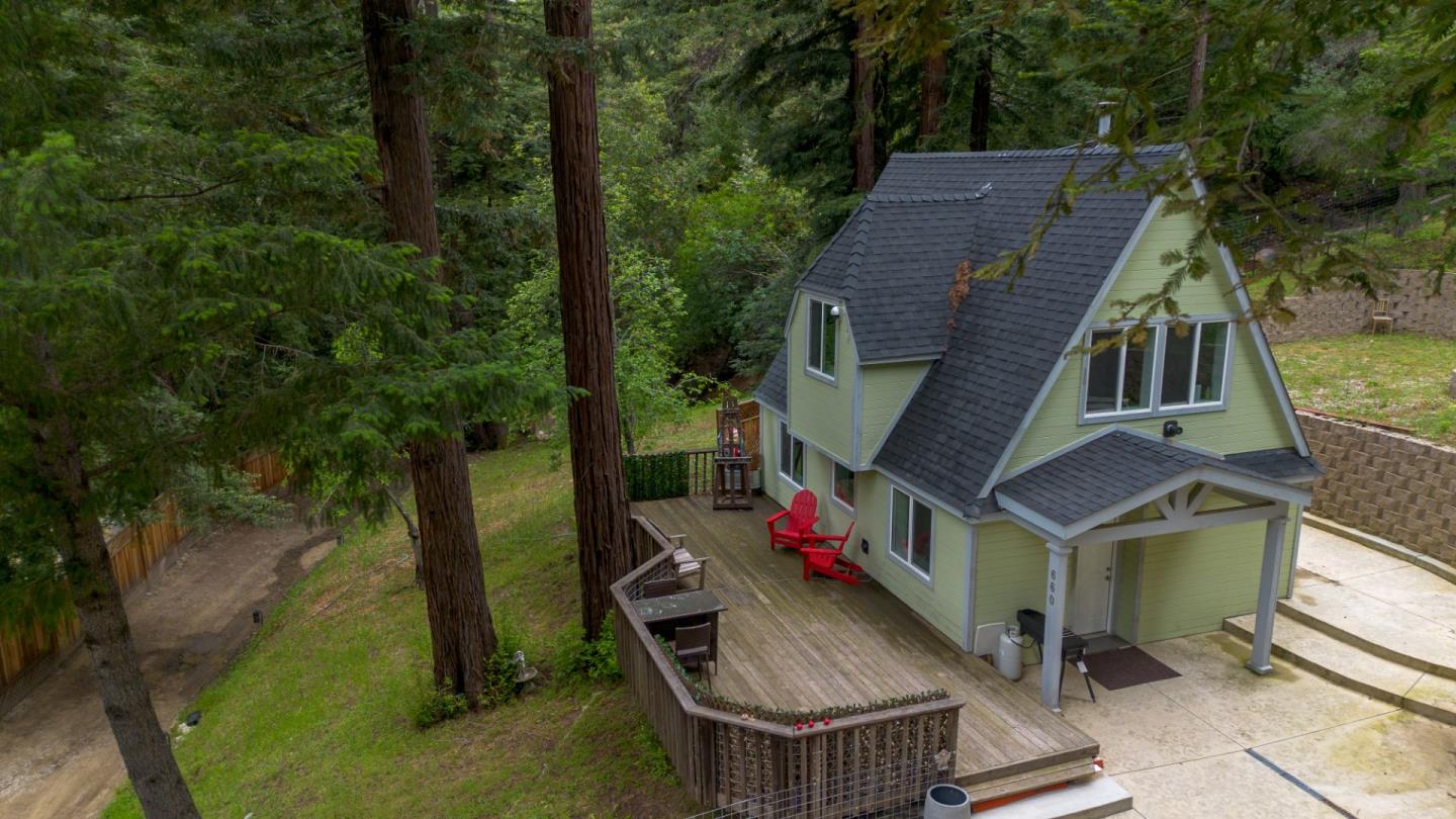 an aerial view of house with backyard space and seating