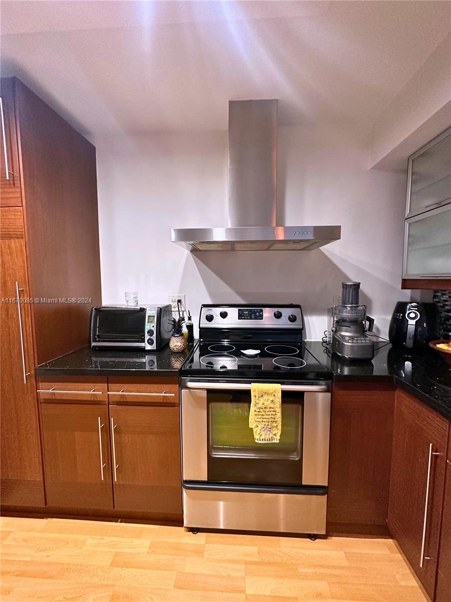 a kitchen with stainless steel appliances granite countertop a stove and a refrigerator