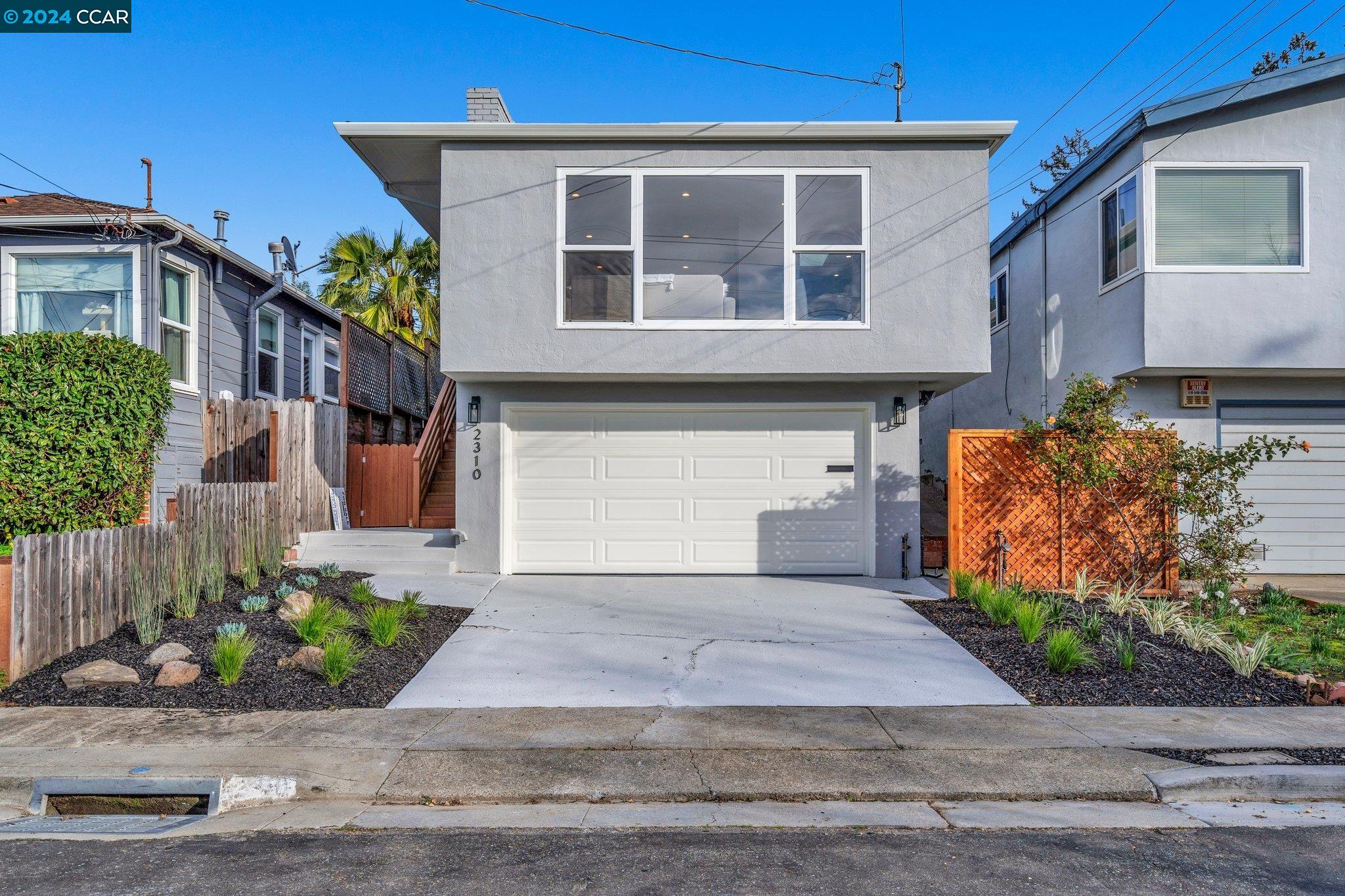 a front view of a house with a yard and a garage