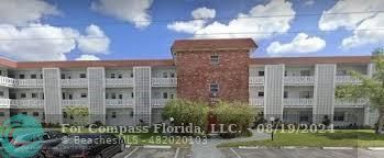 a view of a building with a yard