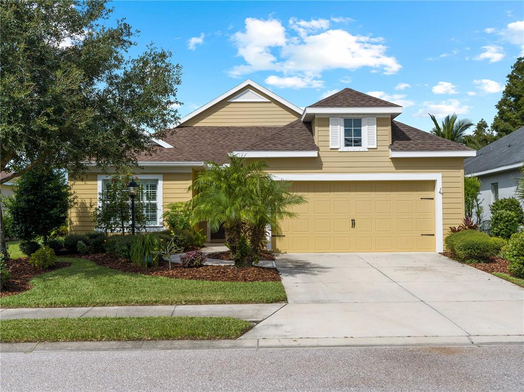 a front view of a house with a yard and garage