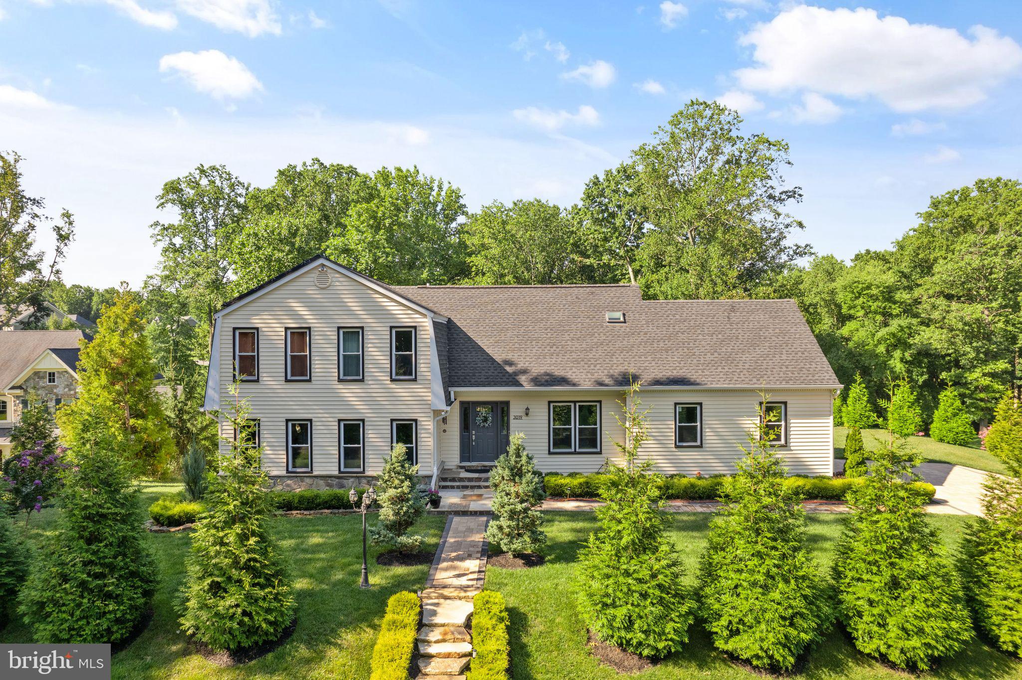 a aerial view of a house with yard and green space