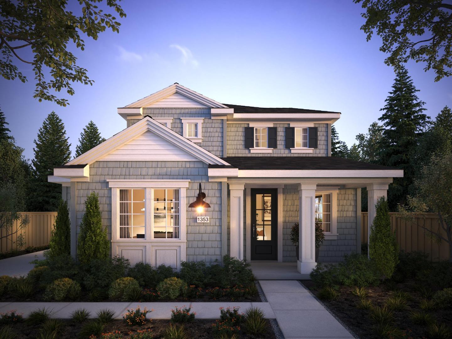 a front view of a house with yard and green space