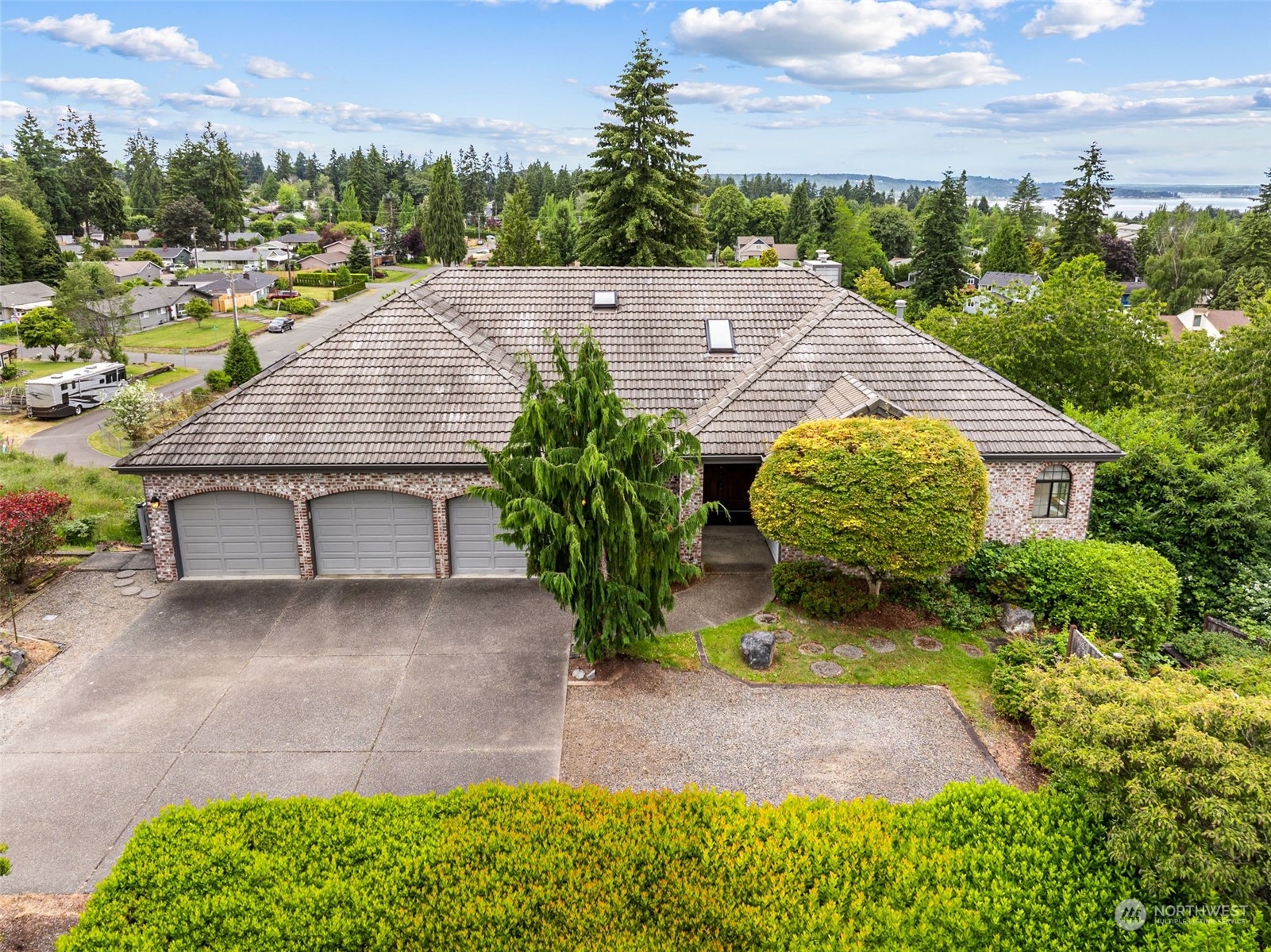 an aerial view of a house with yard and lake view