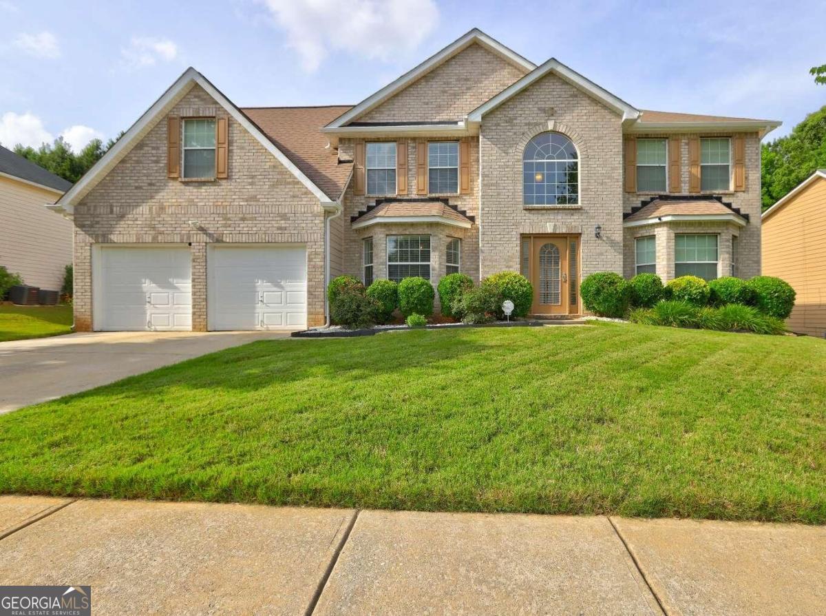 a front view of a house with a yard