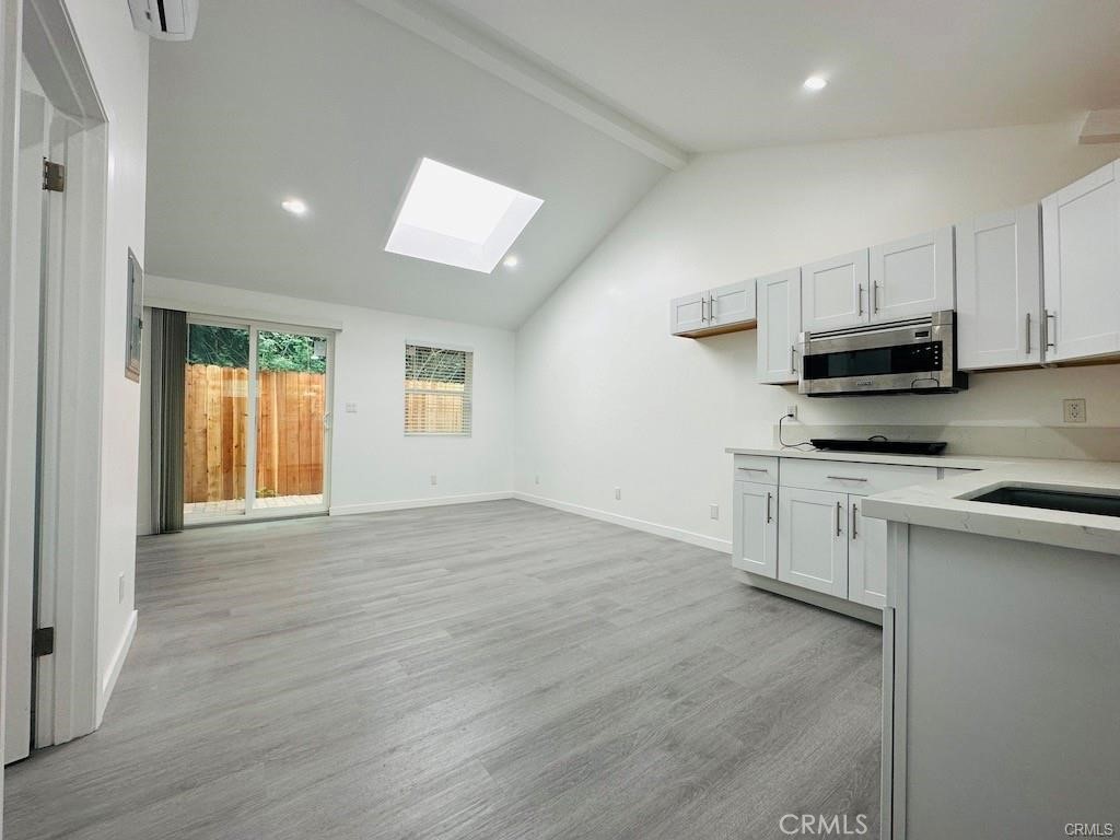 a view of a kitchen with electric appliances