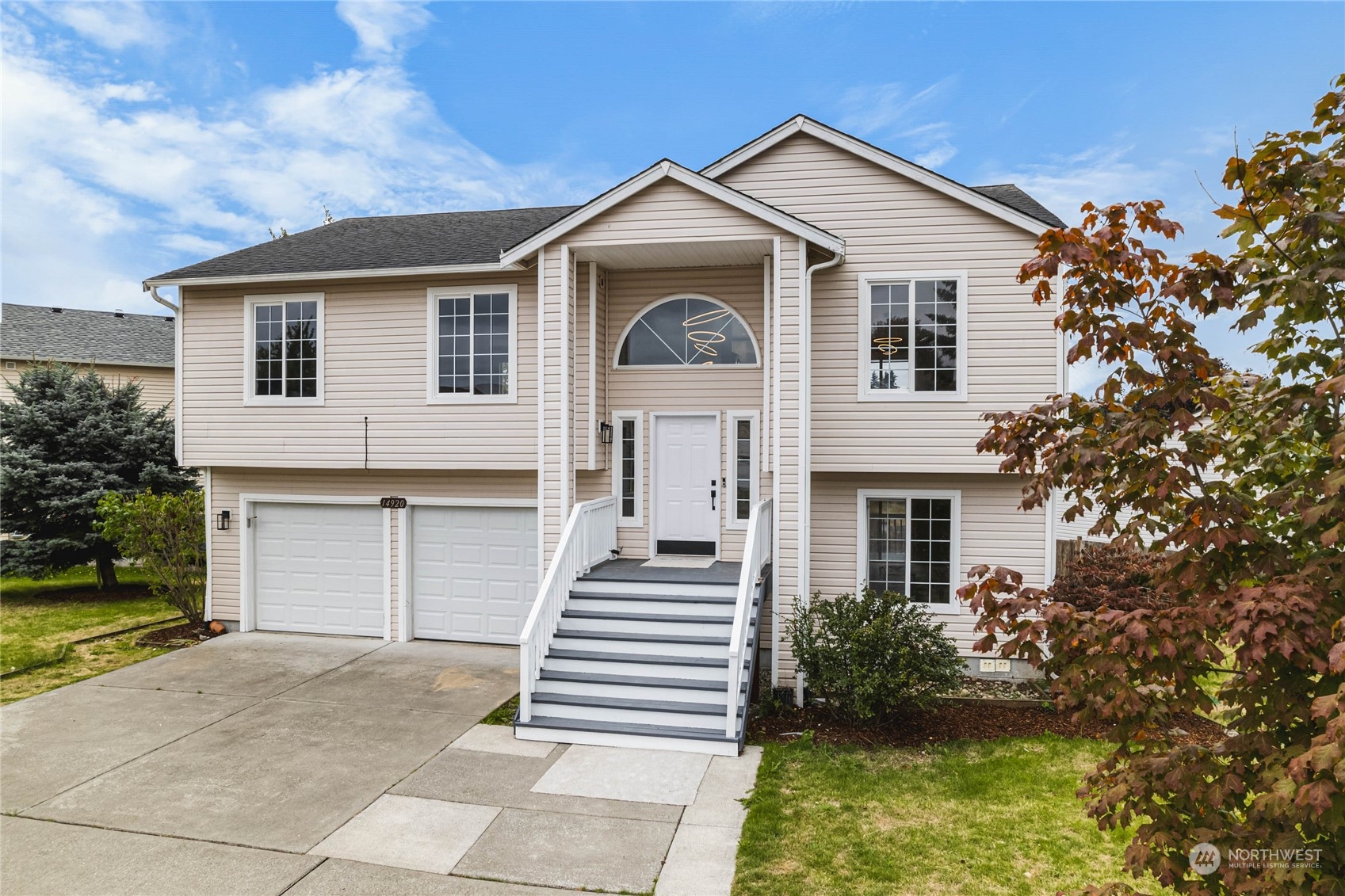 a front view of a house with a garden