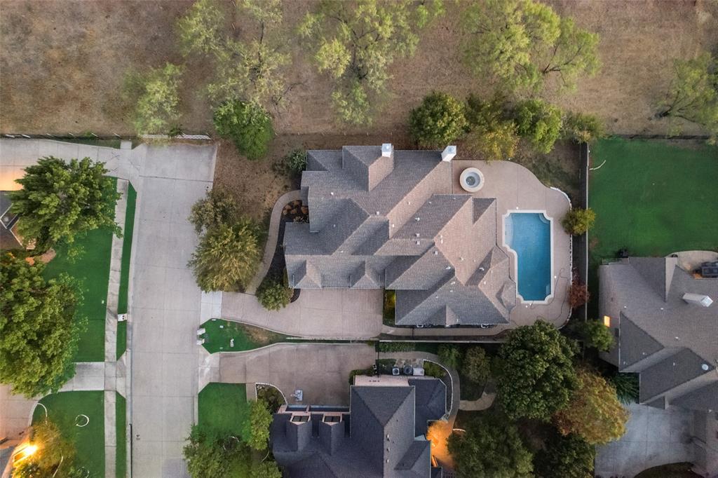 an aerial view of a house with a garden and a swimming pool