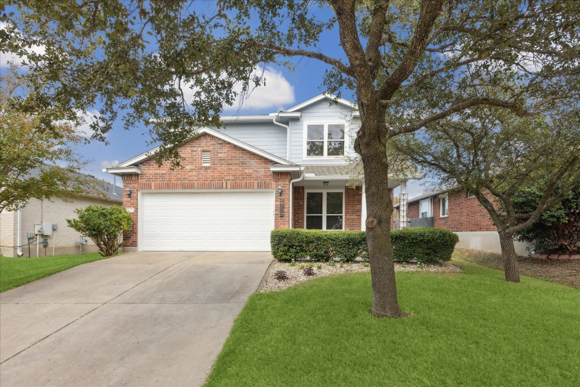 a front view of a house with a garden and yard