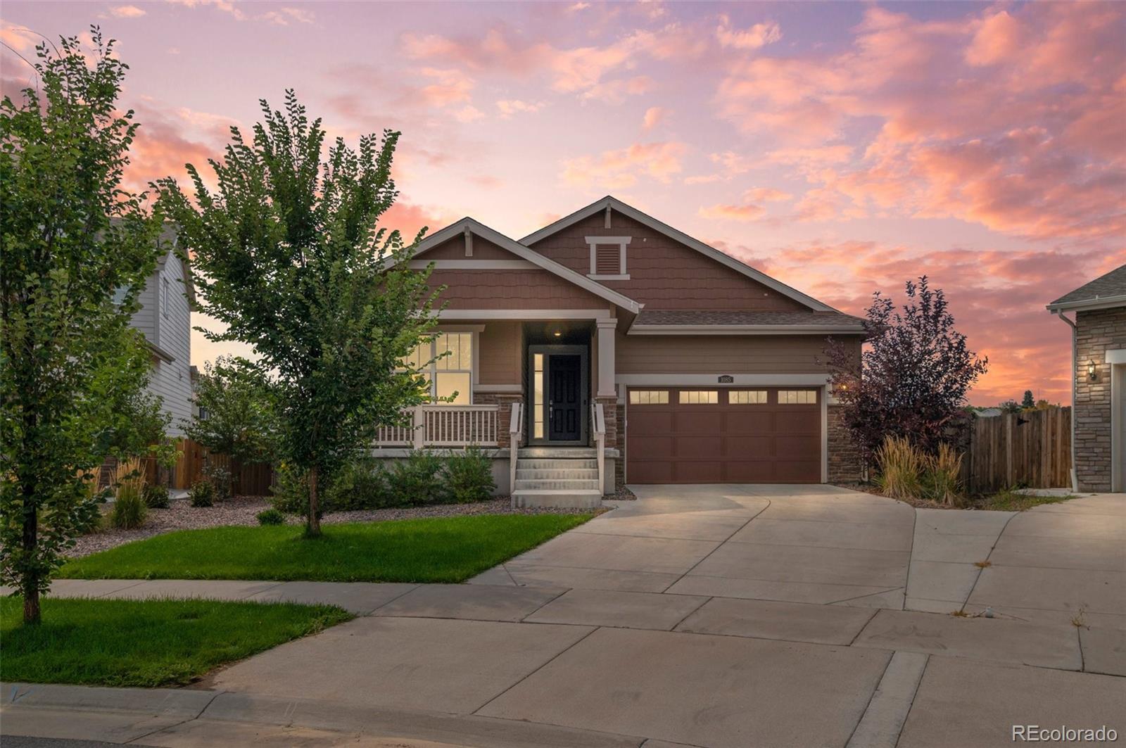 a front view of a house with yard and green space