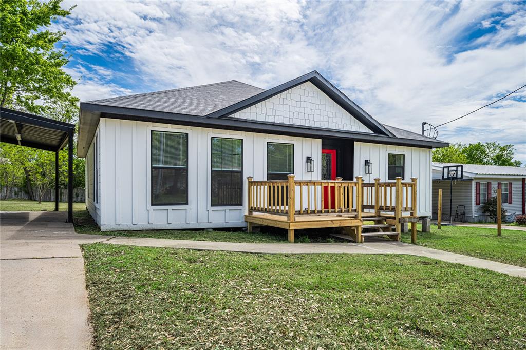 a view of a house with a backyard and porch