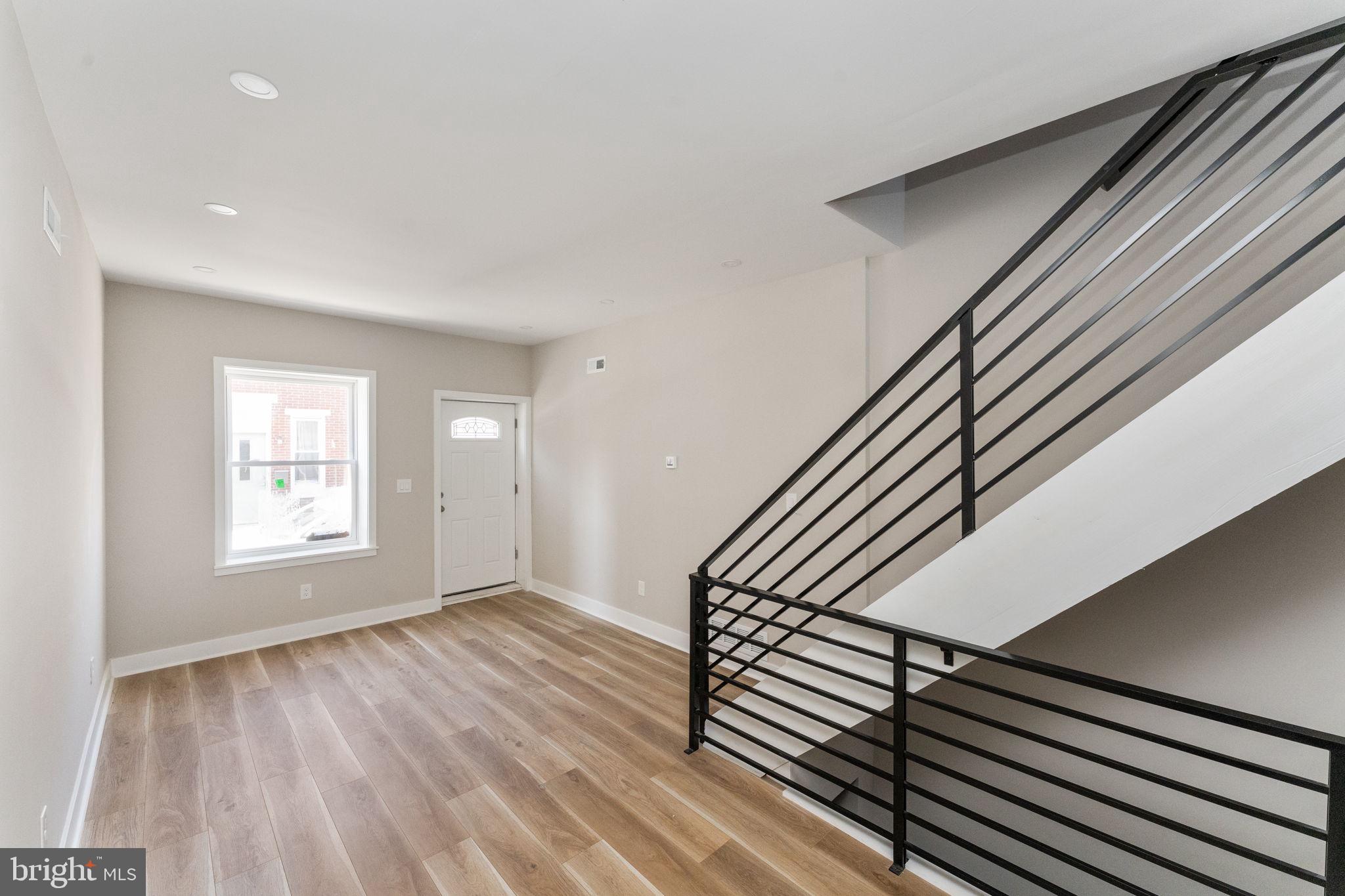 a view of an entryway with wooden floor