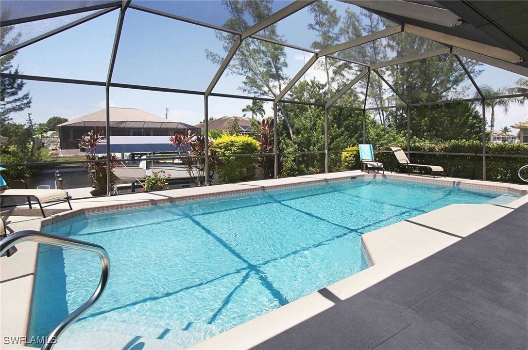 a view of a swimming pool with a chair and tables