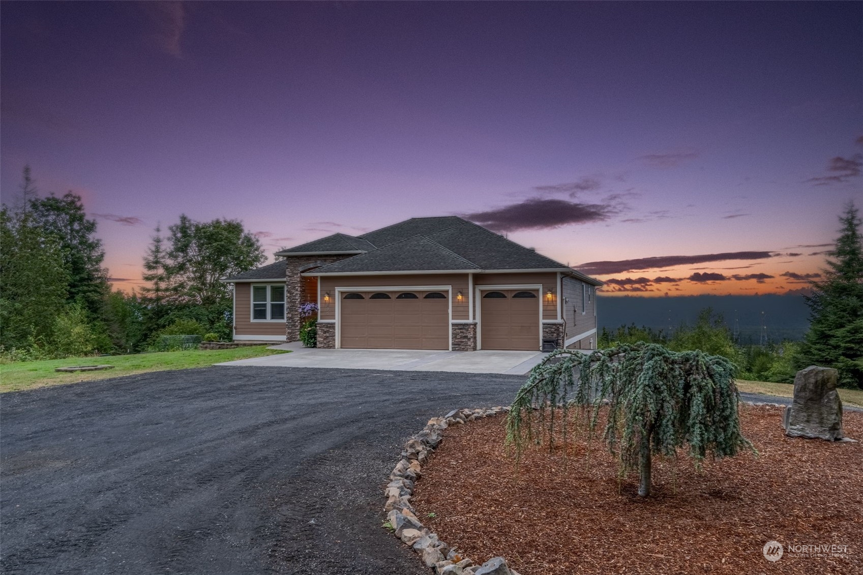 a front view of a house with a yard and a garage