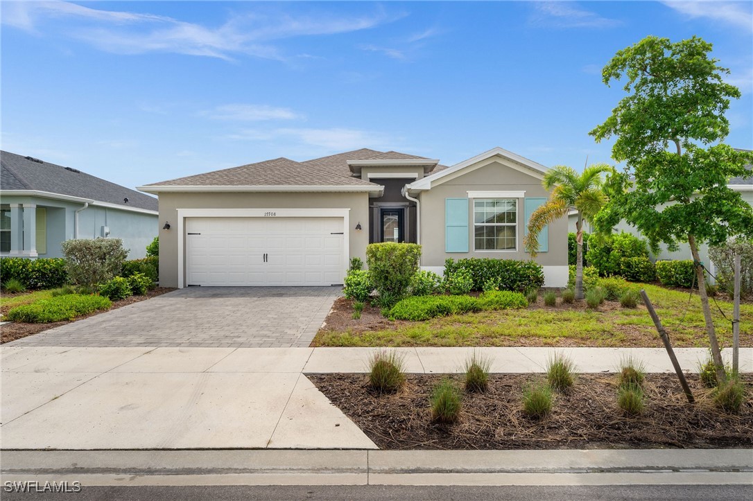 a front view of a house with a yard and garage