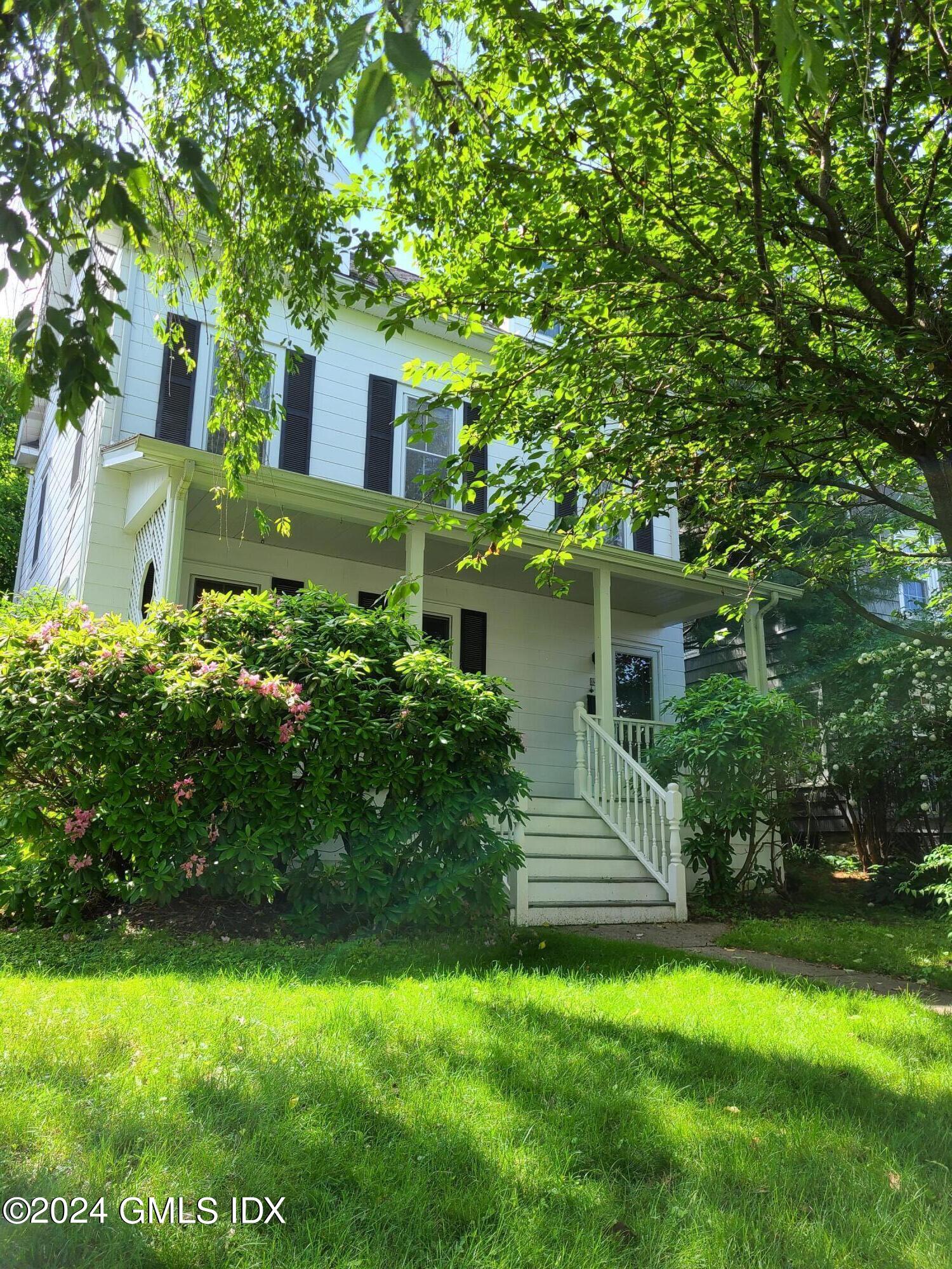 a front view of a house with a garden