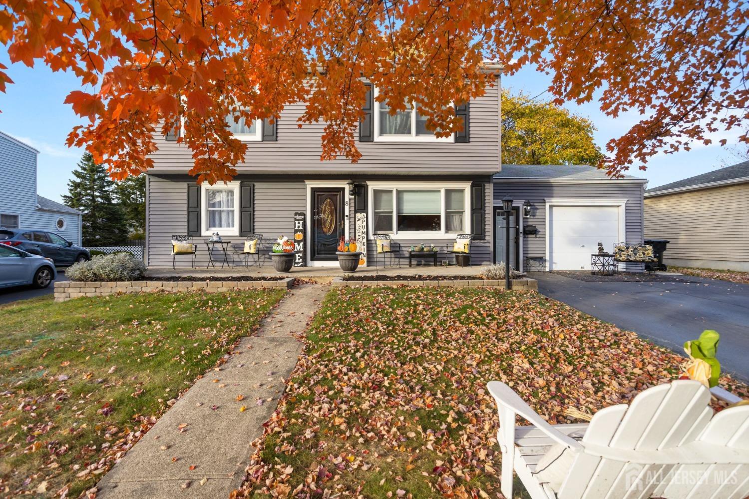 a front view of a house with outdoor seating