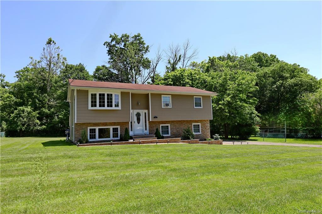 a front view of house with yard and green space