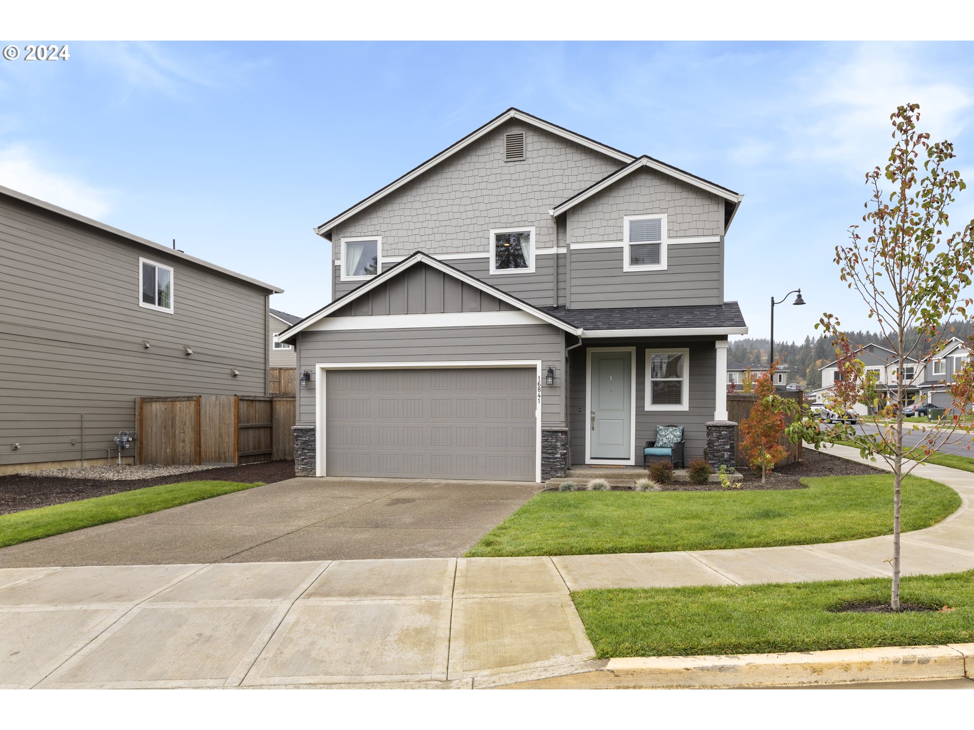 a front view of a house with a yard and garage