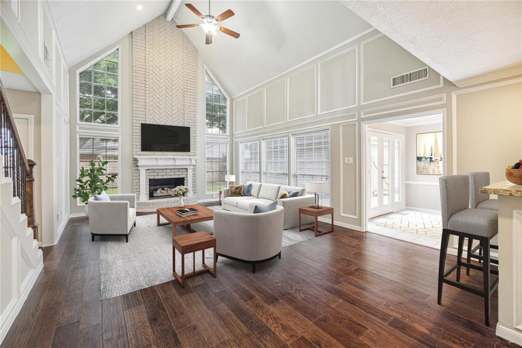 a living room with fireplace furniture and a flat screen tv