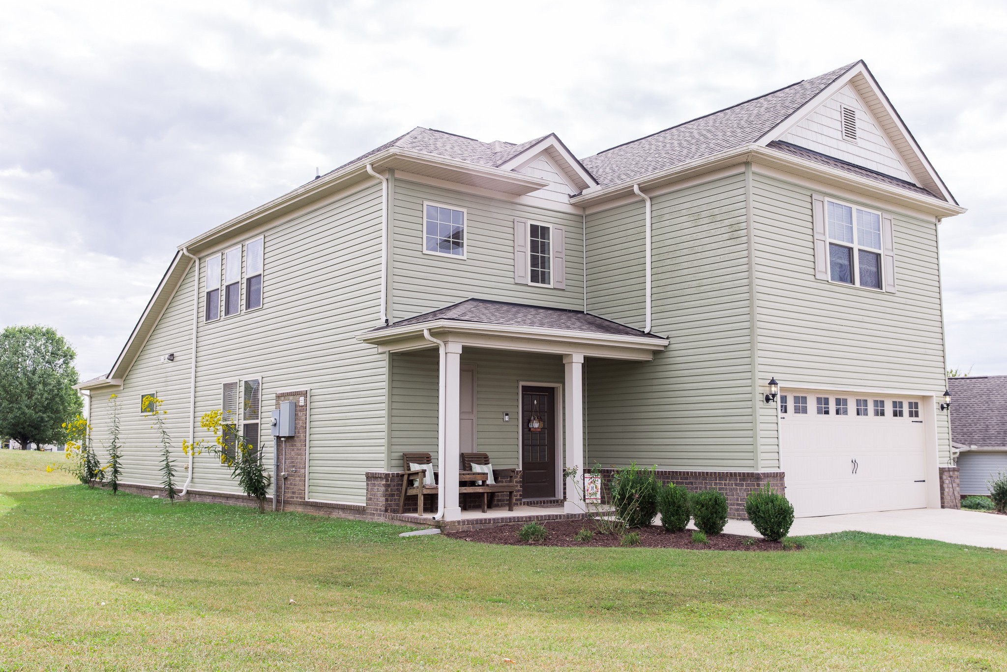 a front view of a house with a yard and garage