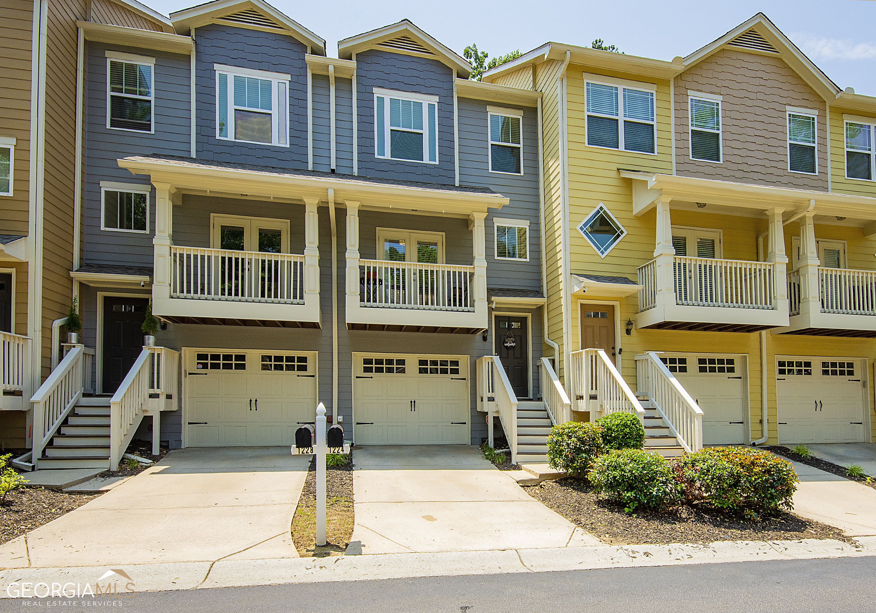 a front view of a residential apartment building with a yard