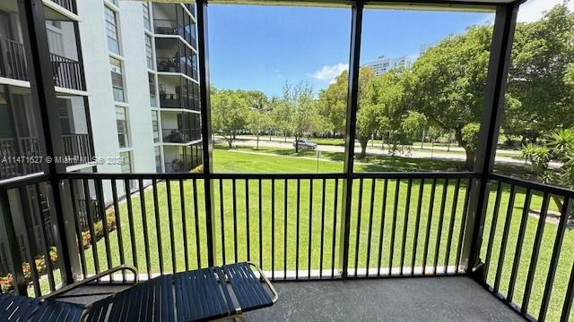 a view of a balcony with a yard