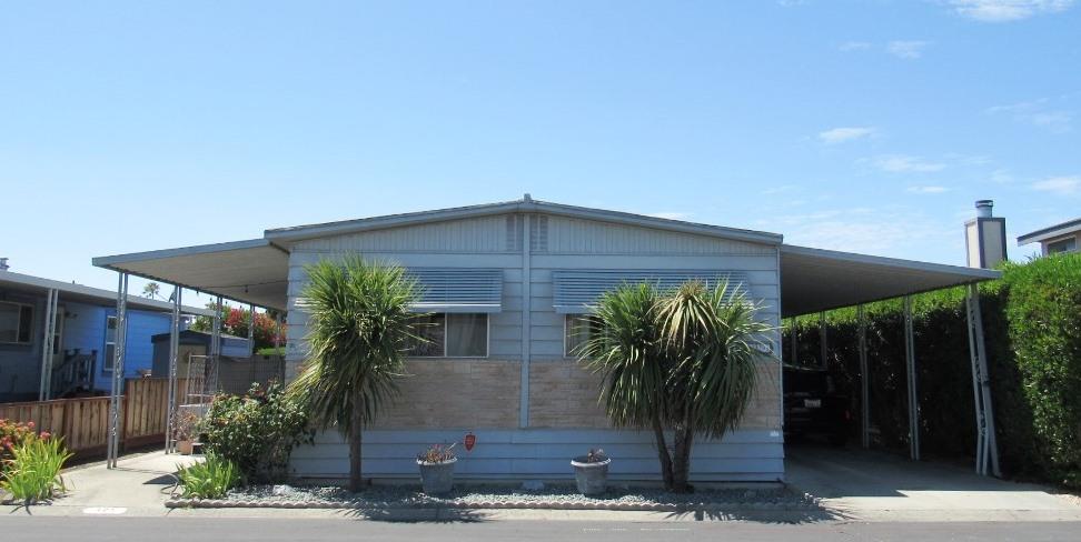 a front view of house with potted plants