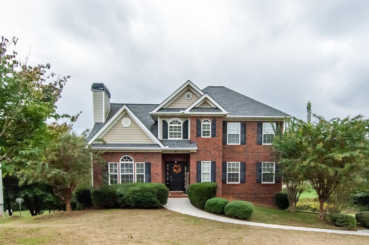 a front view of a house with garden