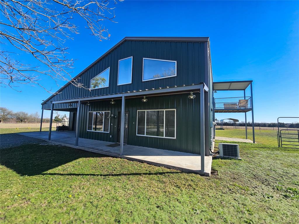 a view of an house with backyard porch and entertaining space