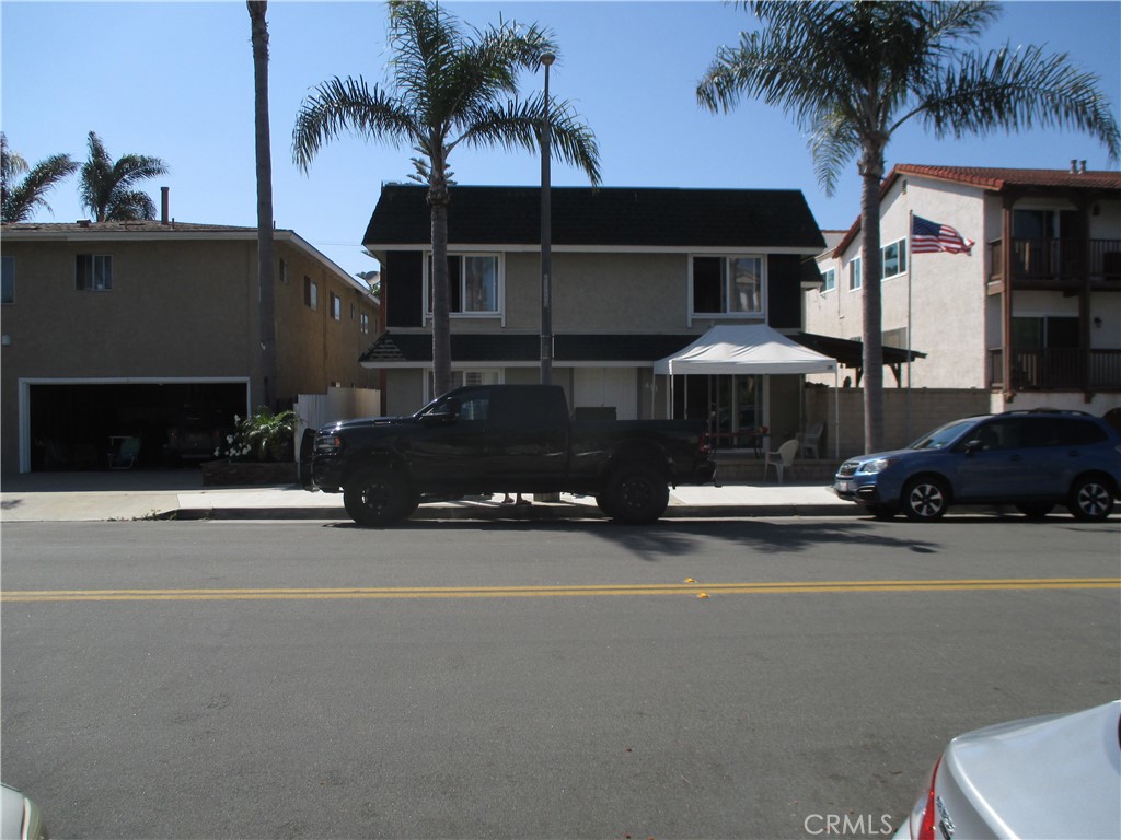 a couple of cars parked in front of a house