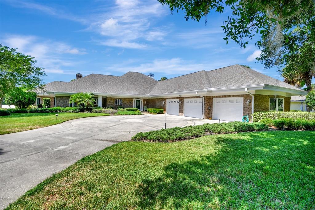 a front view of a house with yard and green space