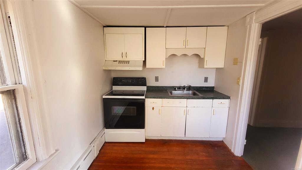 a kitchen with white cabinets and white appliances