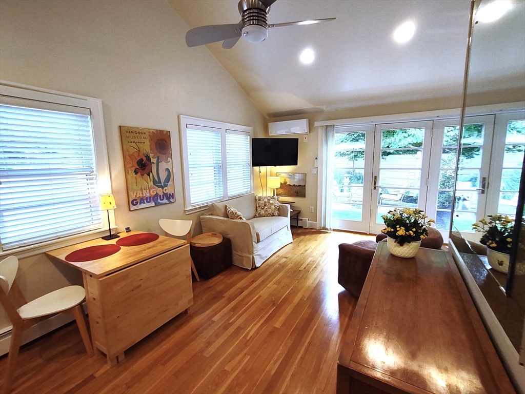 a living room with furniture fireplace and large windows