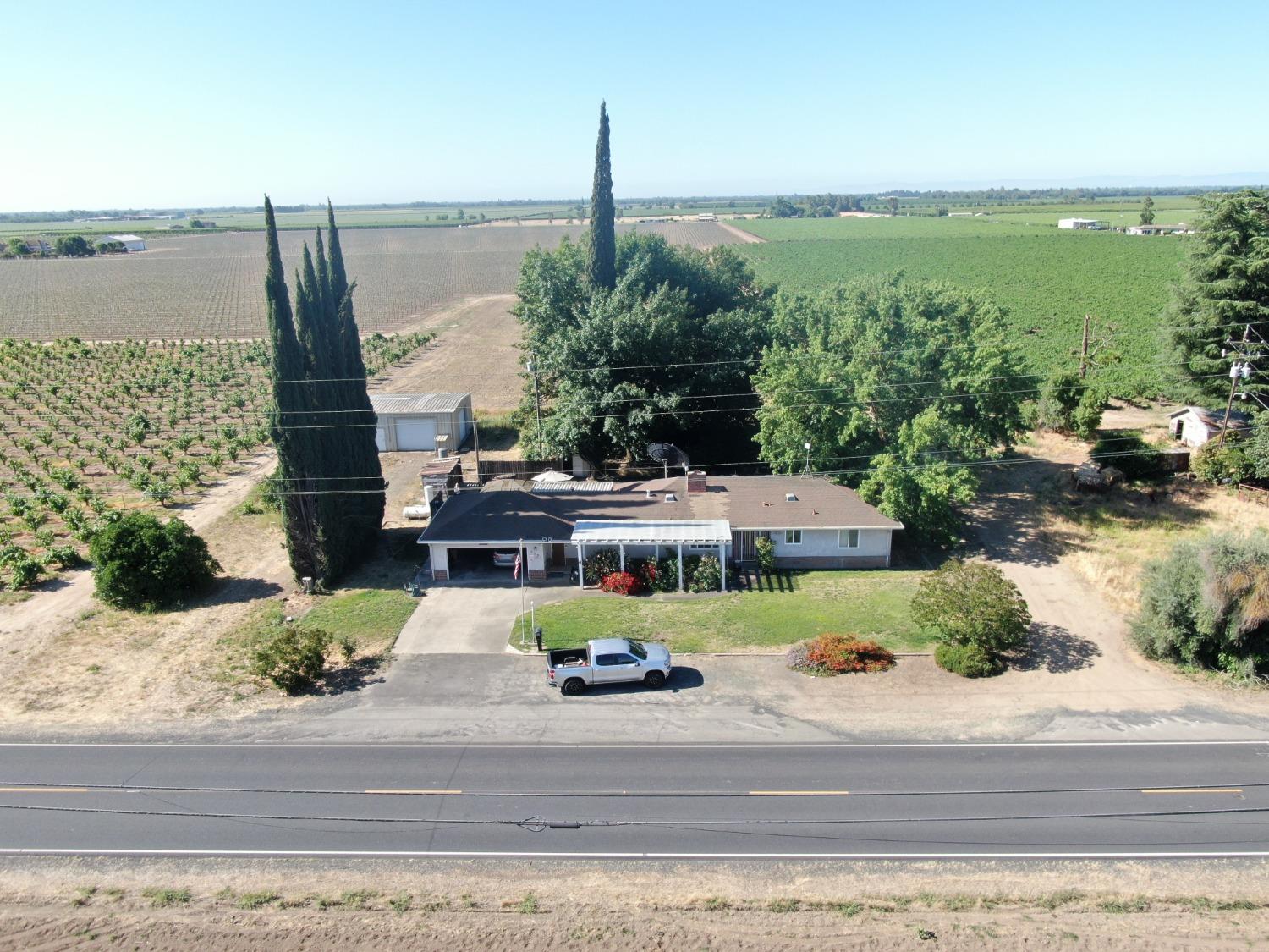 a aerial view of a house with a garden and lake view