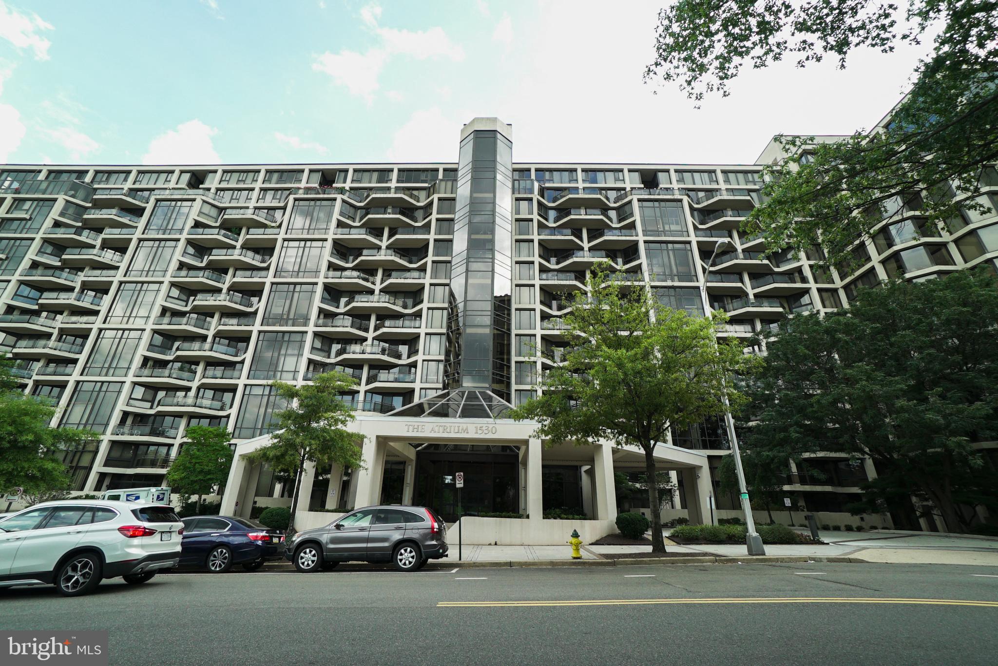 a view of a building and car parked on the road