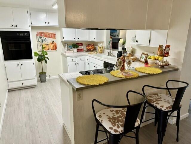 a kitchen with stainless steel appliances kitchen island granite countertop a table chairs in it and white cabinets