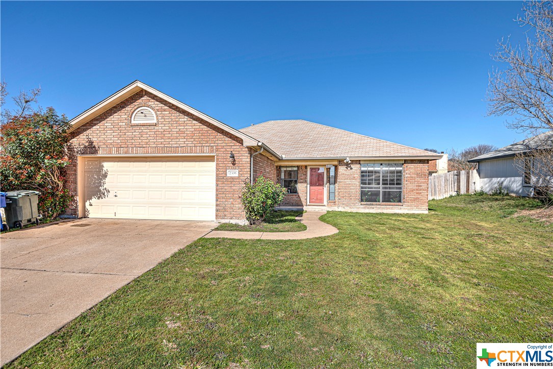 a view of a house with a yard and garage