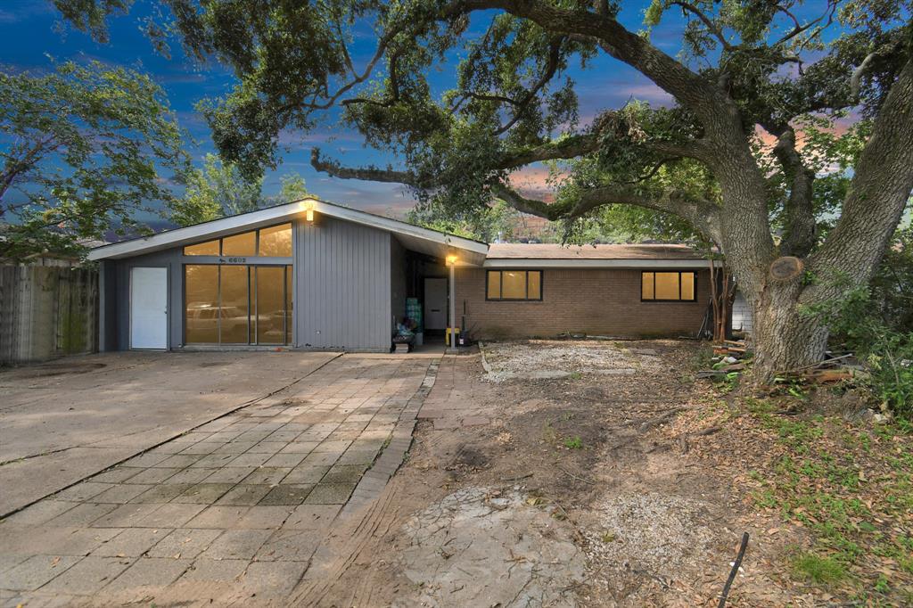 a view of a house with a yard and garage