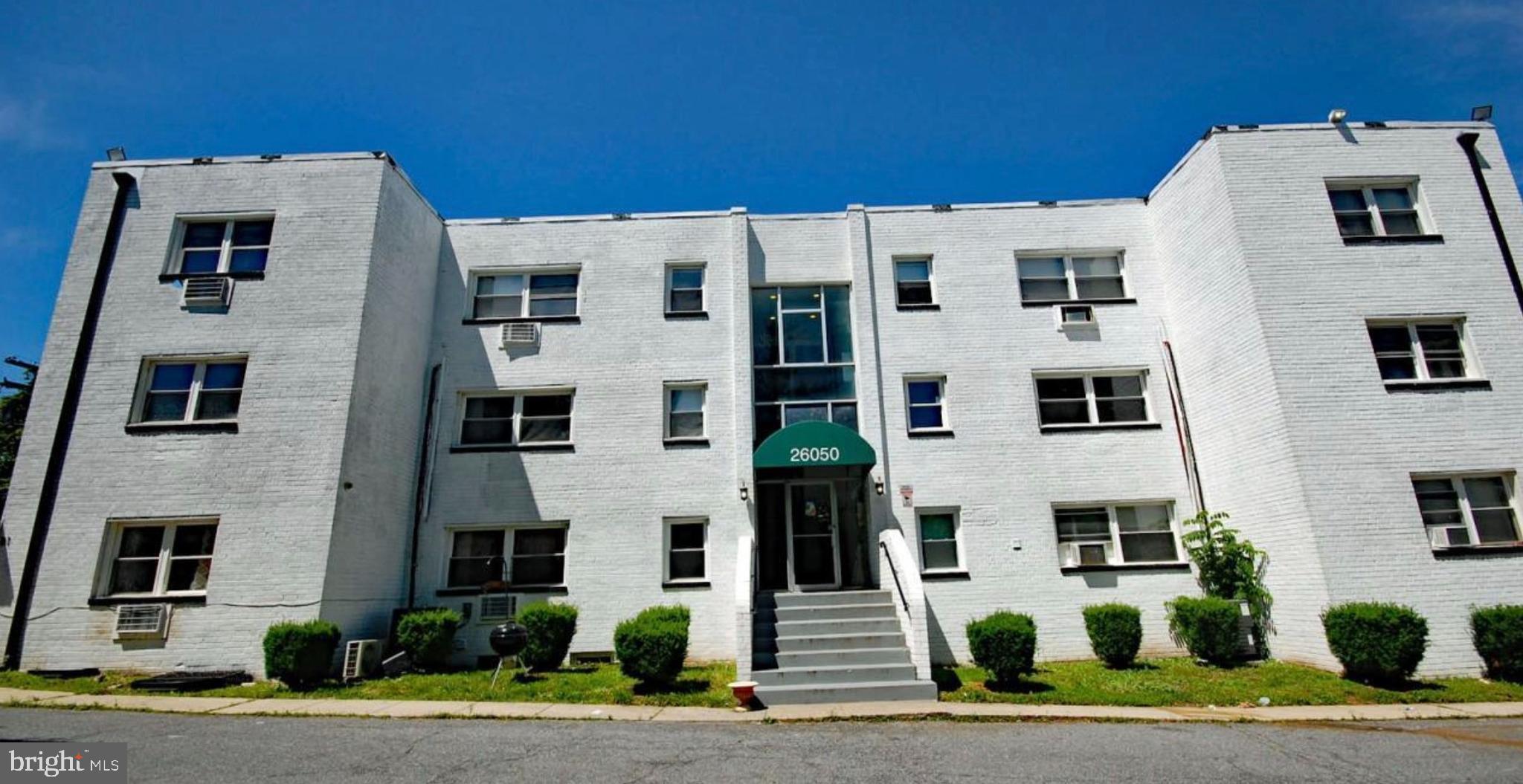 a view of a white building among the street