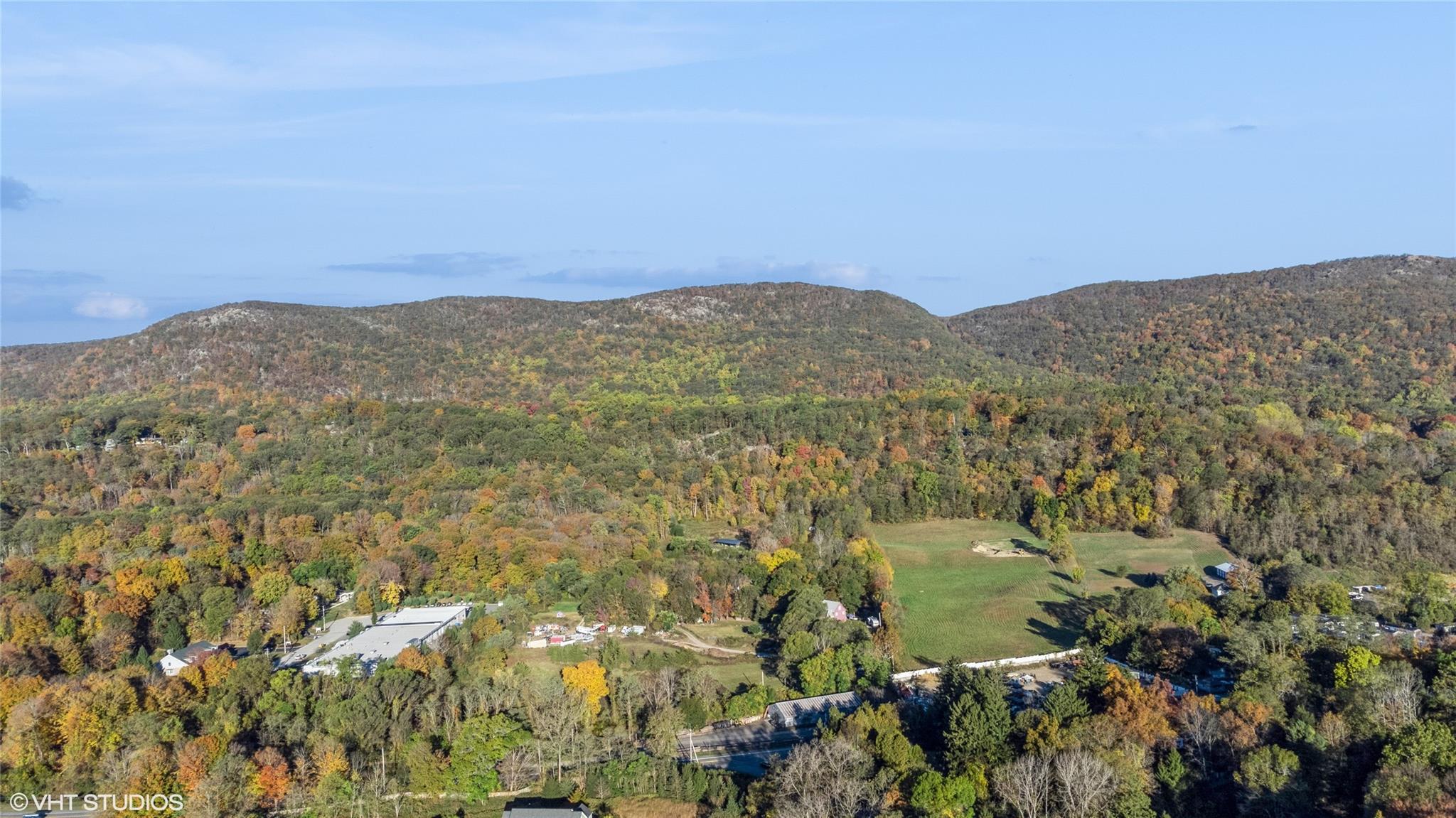 a view of a field with mountains in the background