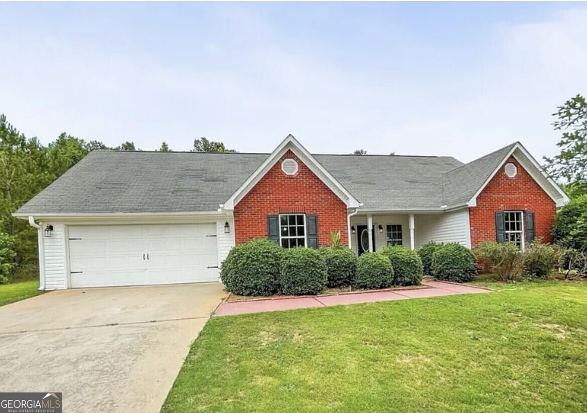 a front view of house with yard and green space