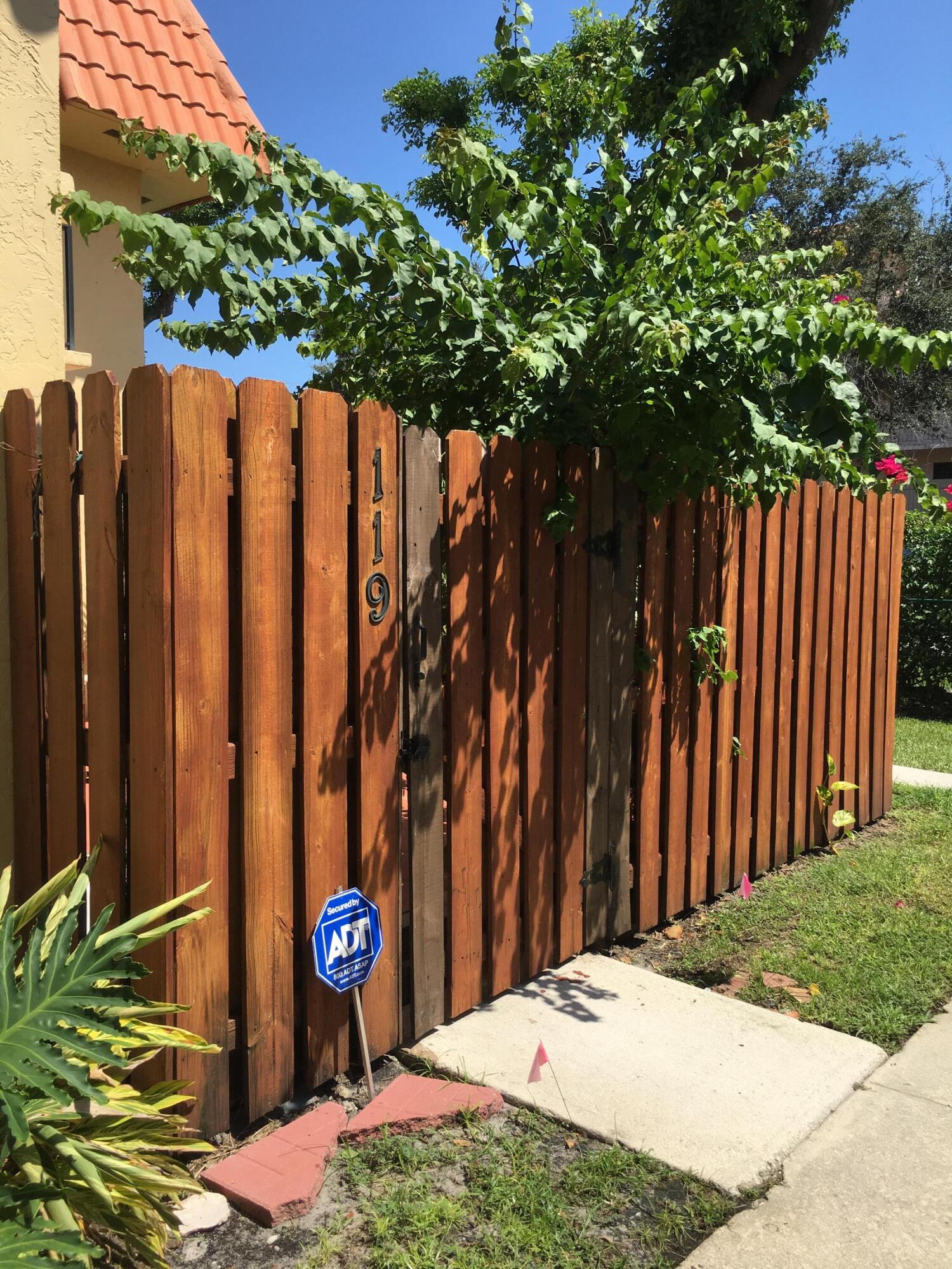 a view of street with wooden fence