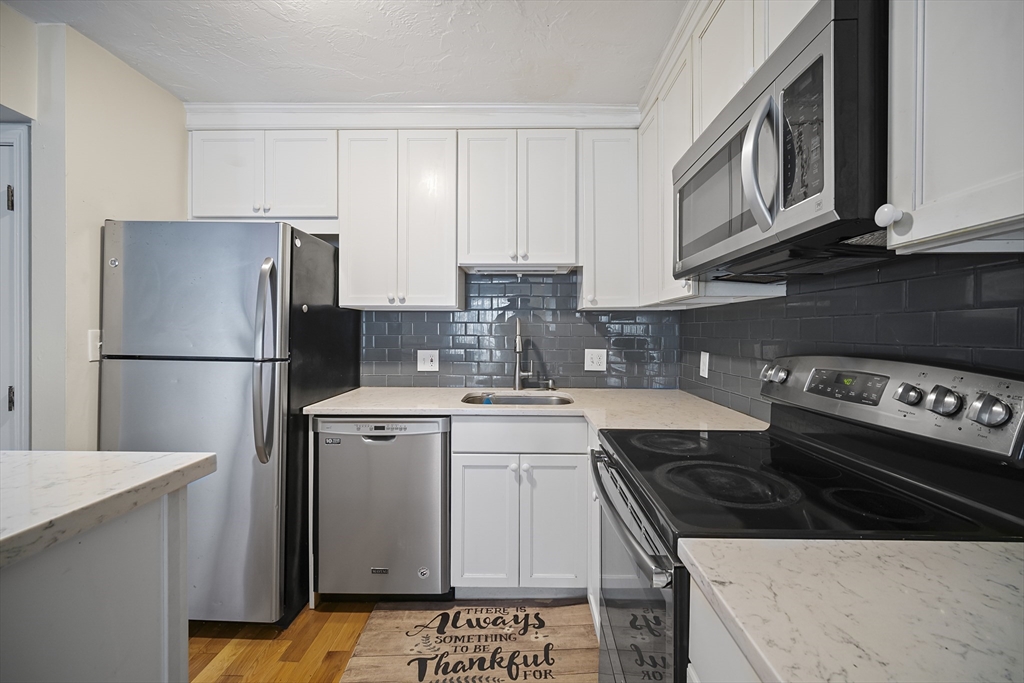 a kitchen with a stove and a refrigerator