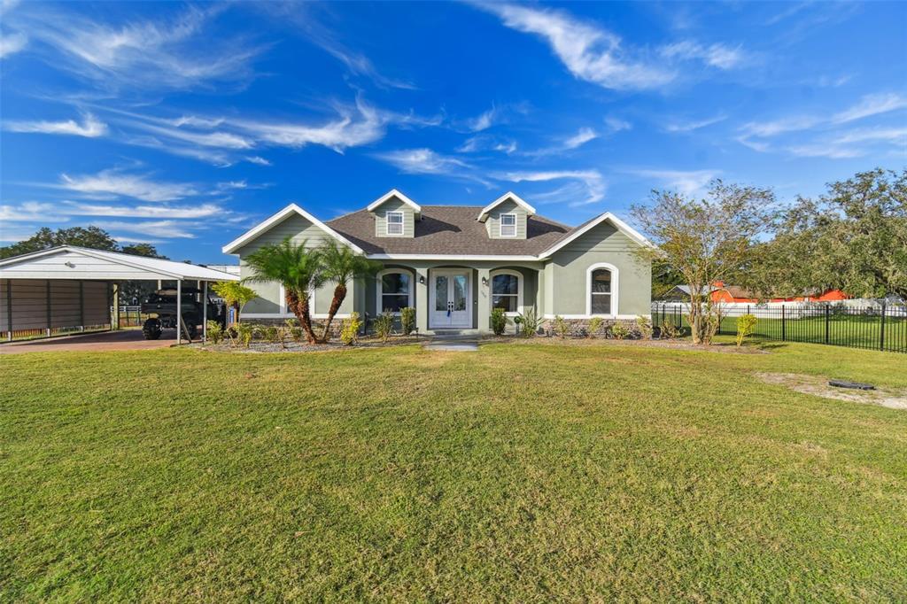 a front view of a house with a garden