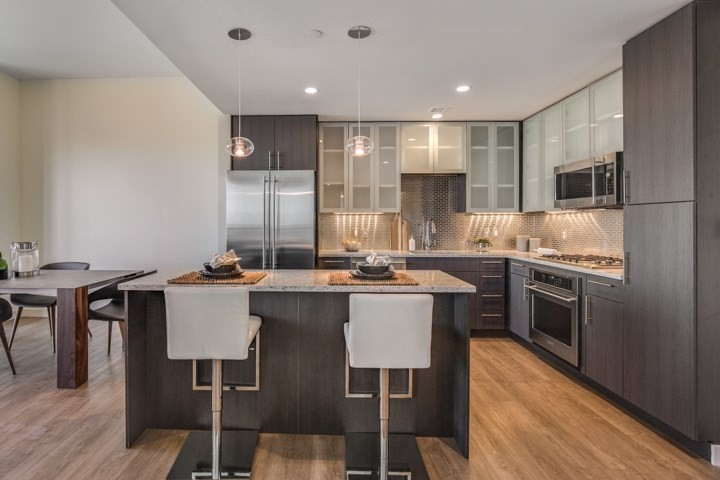 a kitchen with a sink cabinets and wooden floor