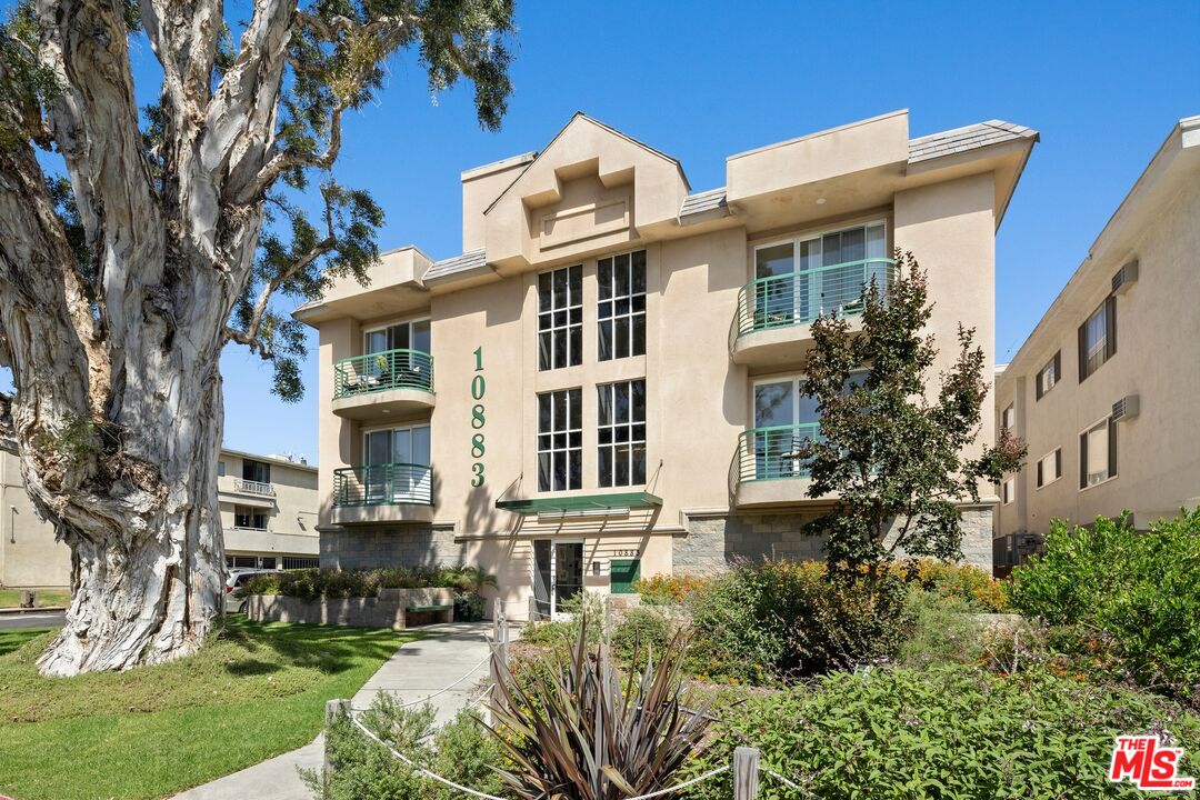 a front view of a residential apartment building with a yard